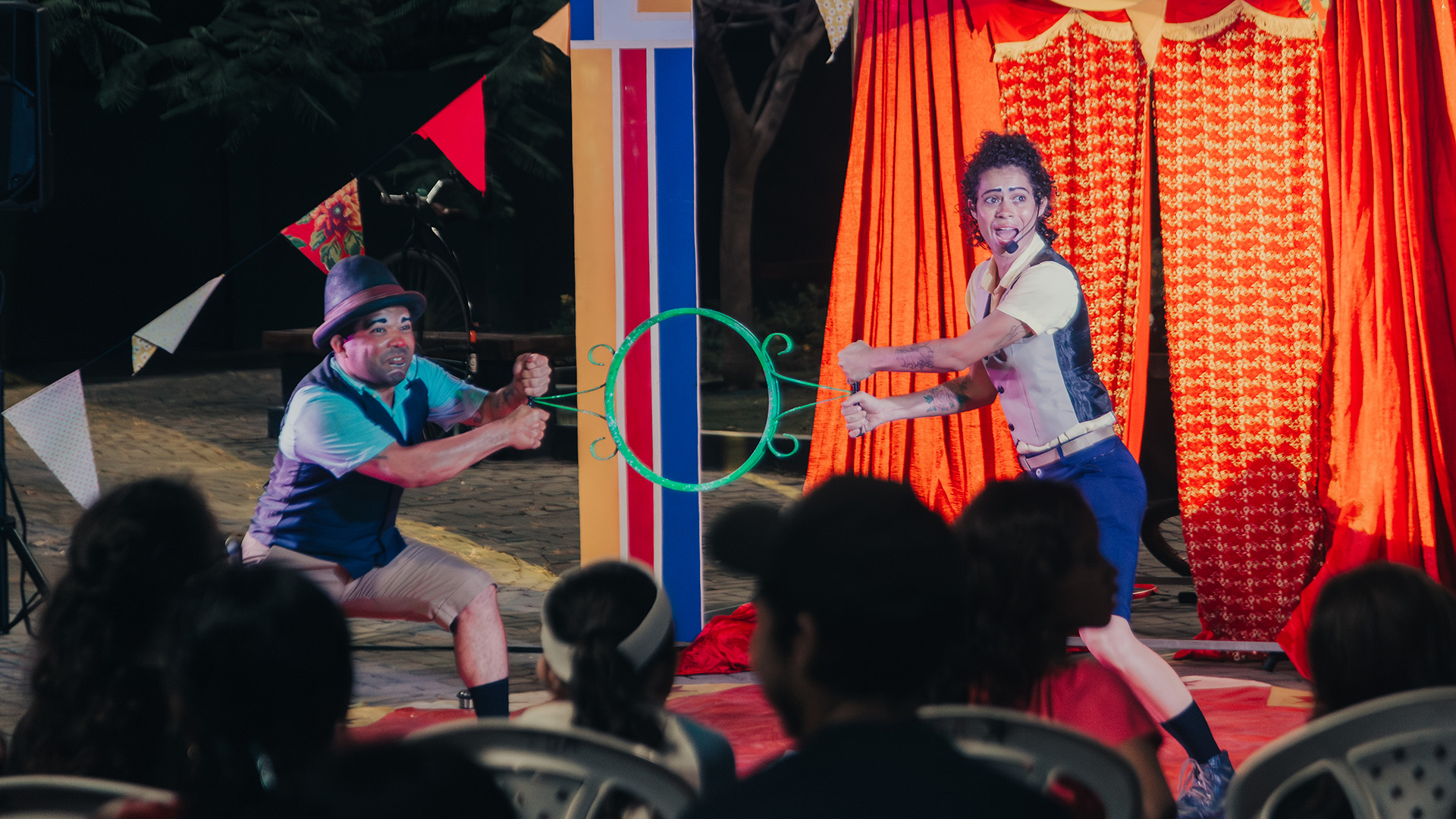 image of acrobats performing in an enchanting tent at an amusement park